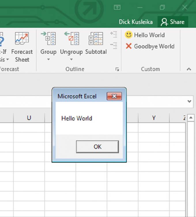 Screenshot shows the right end of the menu bar in an excel along with a pop up window showing hello world message and an OK button.