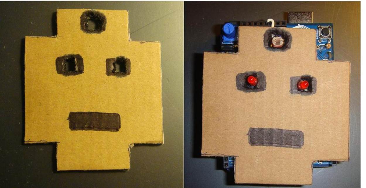 FrankenBot: cut out opening for the photocell and LEDs to pass through cardboard FrankenBot head (left); mount cardboard Frankenbot head on top of MakerShield Interactive Twin LED Flasher (right)
