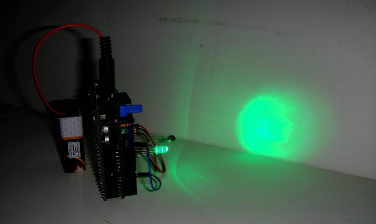Pocket Stage Light projecting a green light on a whiteboard