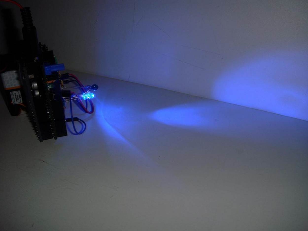 Pocket Stage Light projecting a blue light on a whiteboard