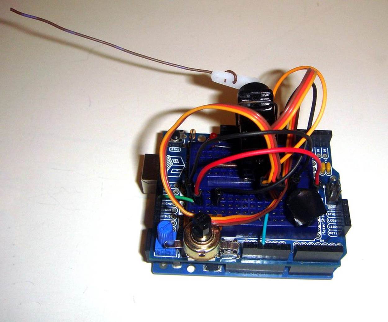View of 10KΩ potentiometer (volume control) and piezo buzzer (with tape)