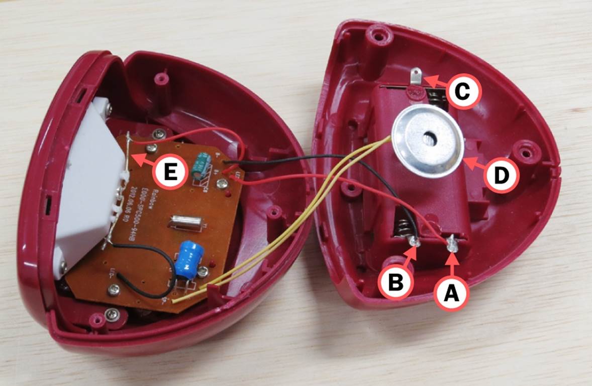 3V battery power is delivered through tabs A and B. Tab C has no connection. D identifies the beeper. E connects with an LED that lights the display when the alarm goes off.