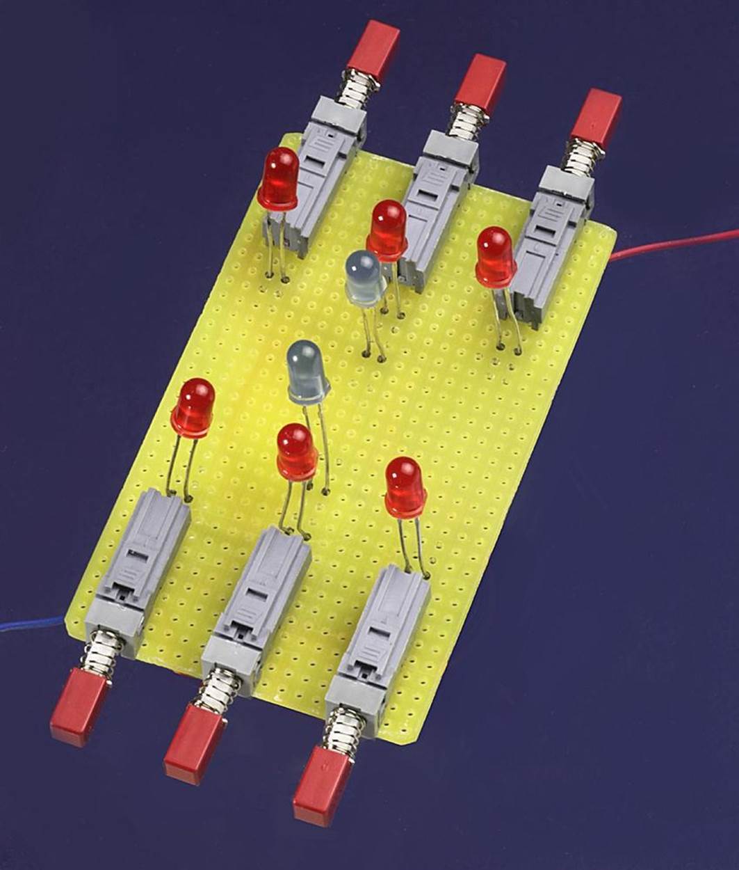 The top of the rock-paper-scissors circuit. The LED leads were left long so that they could be pushed up through holes in the lid of an enclosure.