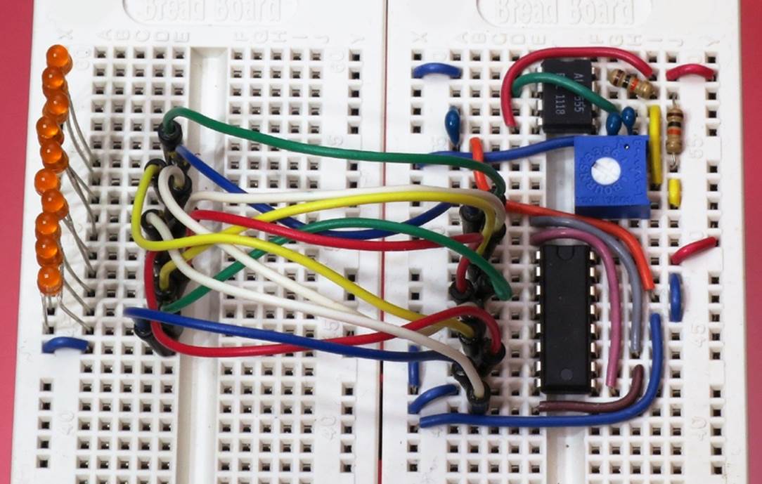 Jumpers can be used to unscramble the counter outputs and power a line of LEDs that will light up in numerical order. The components at the top of the breadboard in this photograph will run a demo of the counter, described below.