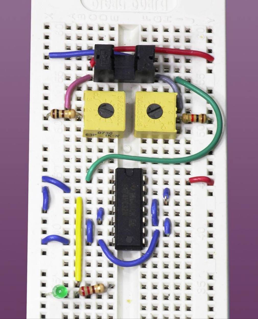 Breadboarded version of the test circuit for a transmissive optical sensor. The U-shaped sensor is at the top, just above the trimmer potentiometers.