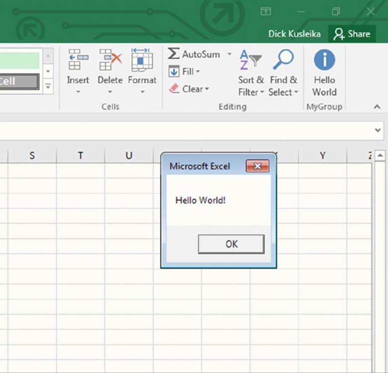 Screenshot shows the right end of the menu bar in an excel along with a pop up window showing hello world message and an OK button.