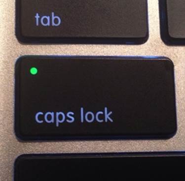 A MacBook Caps Lock key, with its “mode on” indicator lit