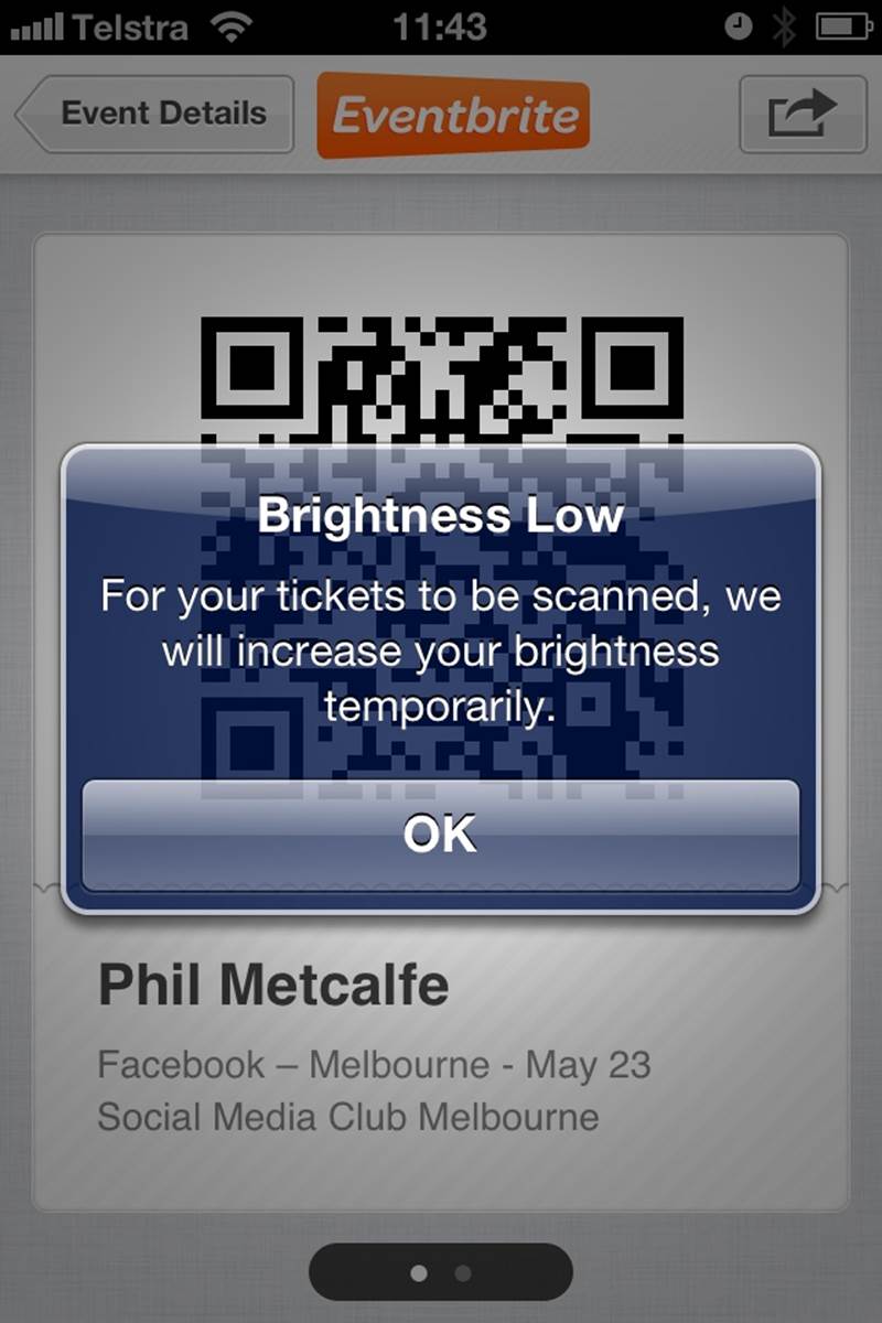The Eventbrite iOS app increases the brightness of the Mobile Ticket screen for easier scanning of the QR code. Useful for the context. The alert is probably unnecessary, however. (Courtesy Phil Metcalfe and Little Big Details.)