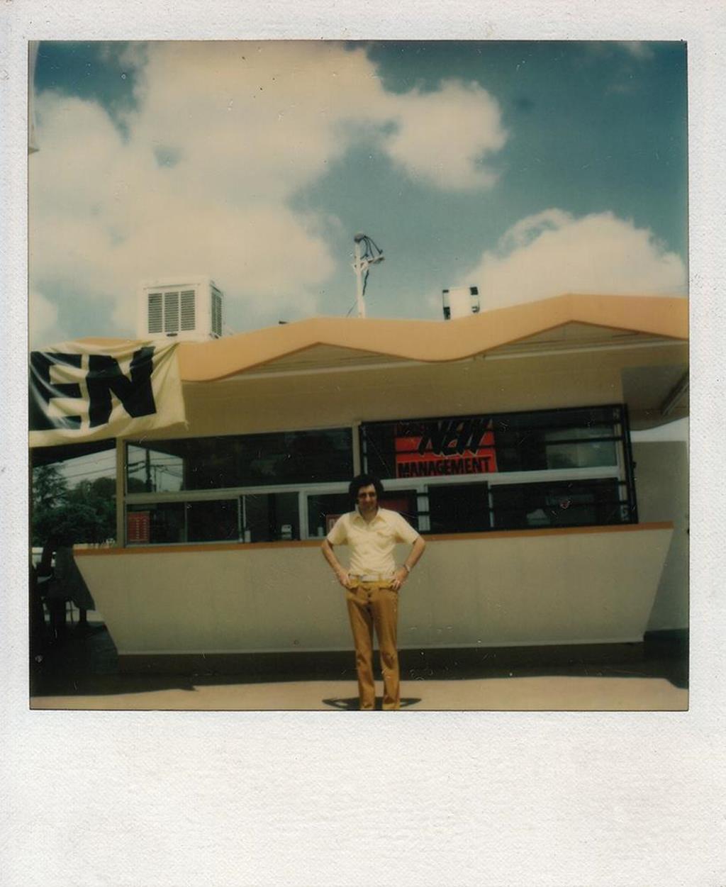 Polaroid of Alan Levy in front of his hot dog stand in 1978